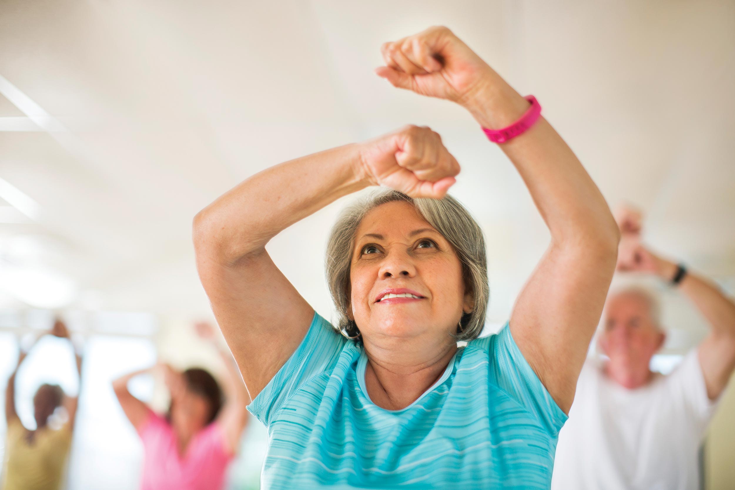 Woman participates in active older adult exercise class