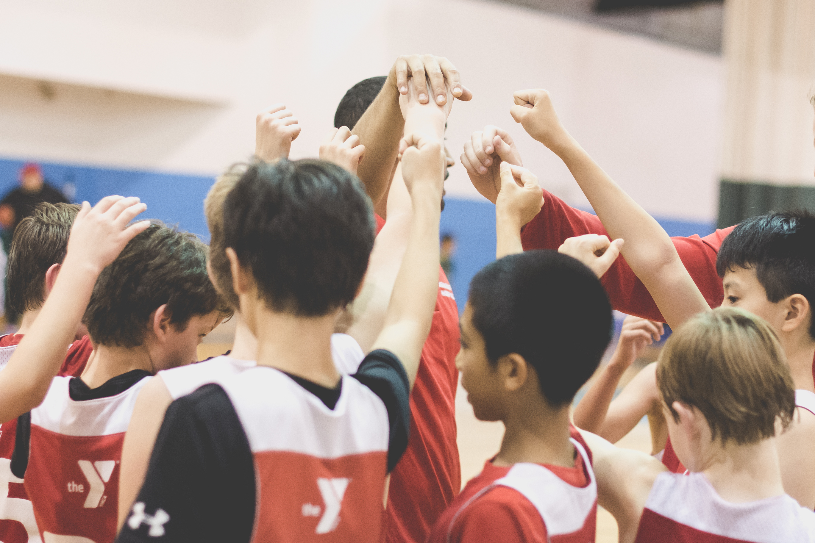 Youth basketball team gathers for huddle