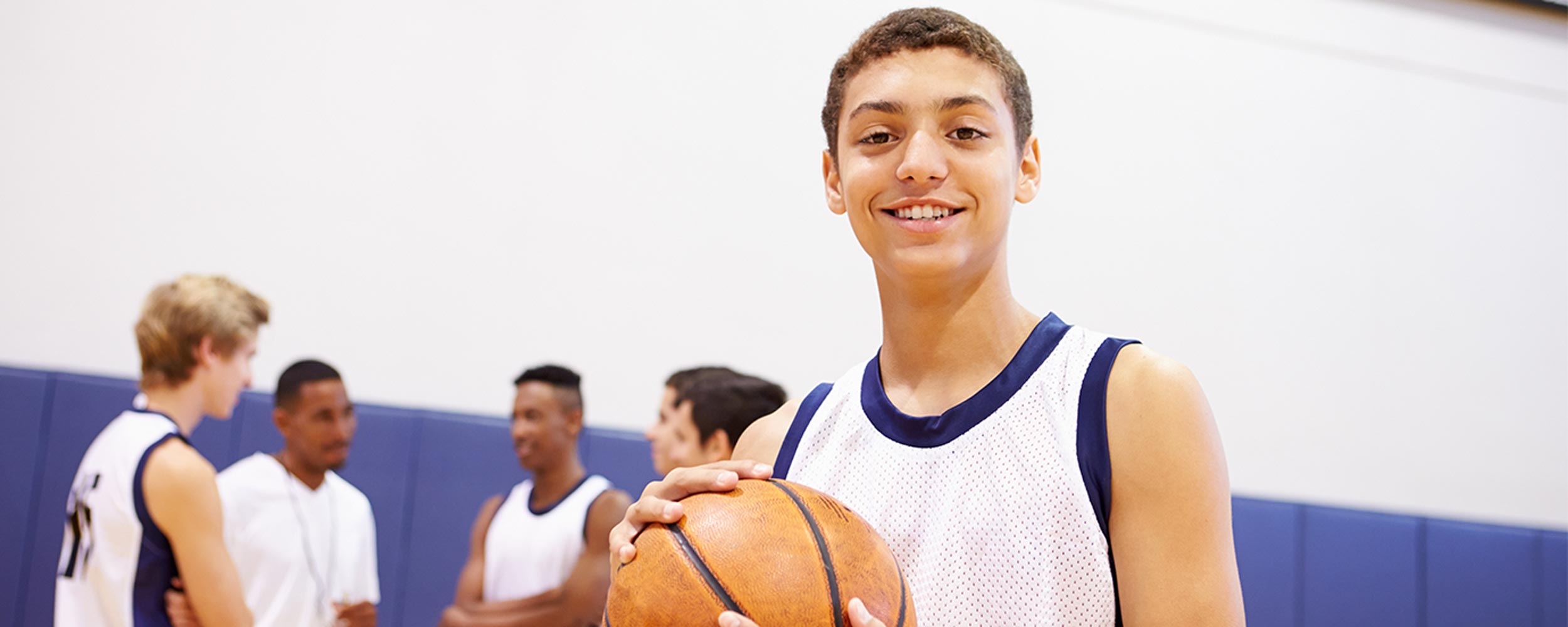 Teen male holding a basketball