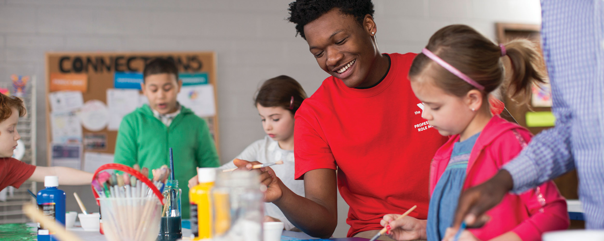 YMCA teacher doing crafts with kids