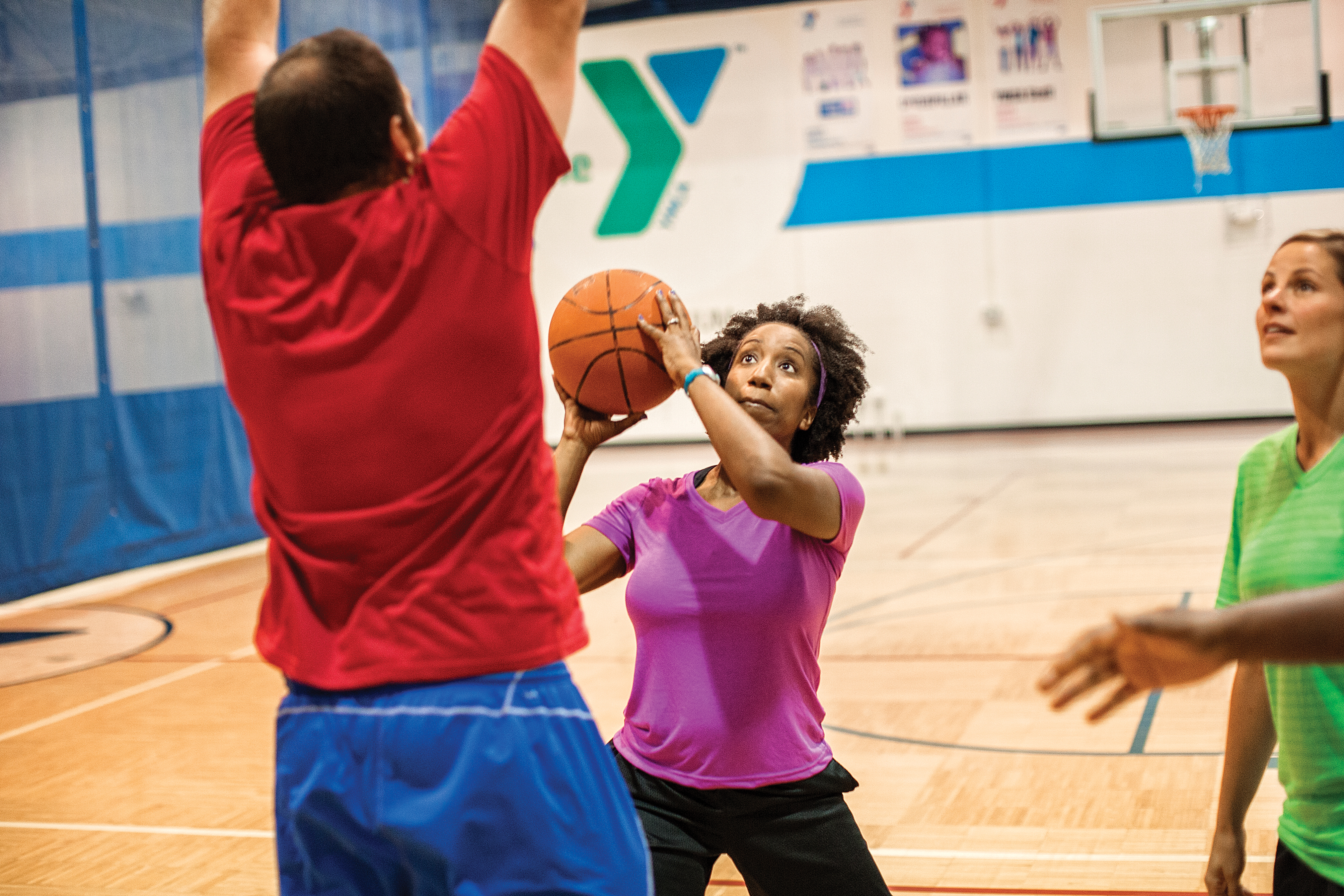 Adults playing basketball
